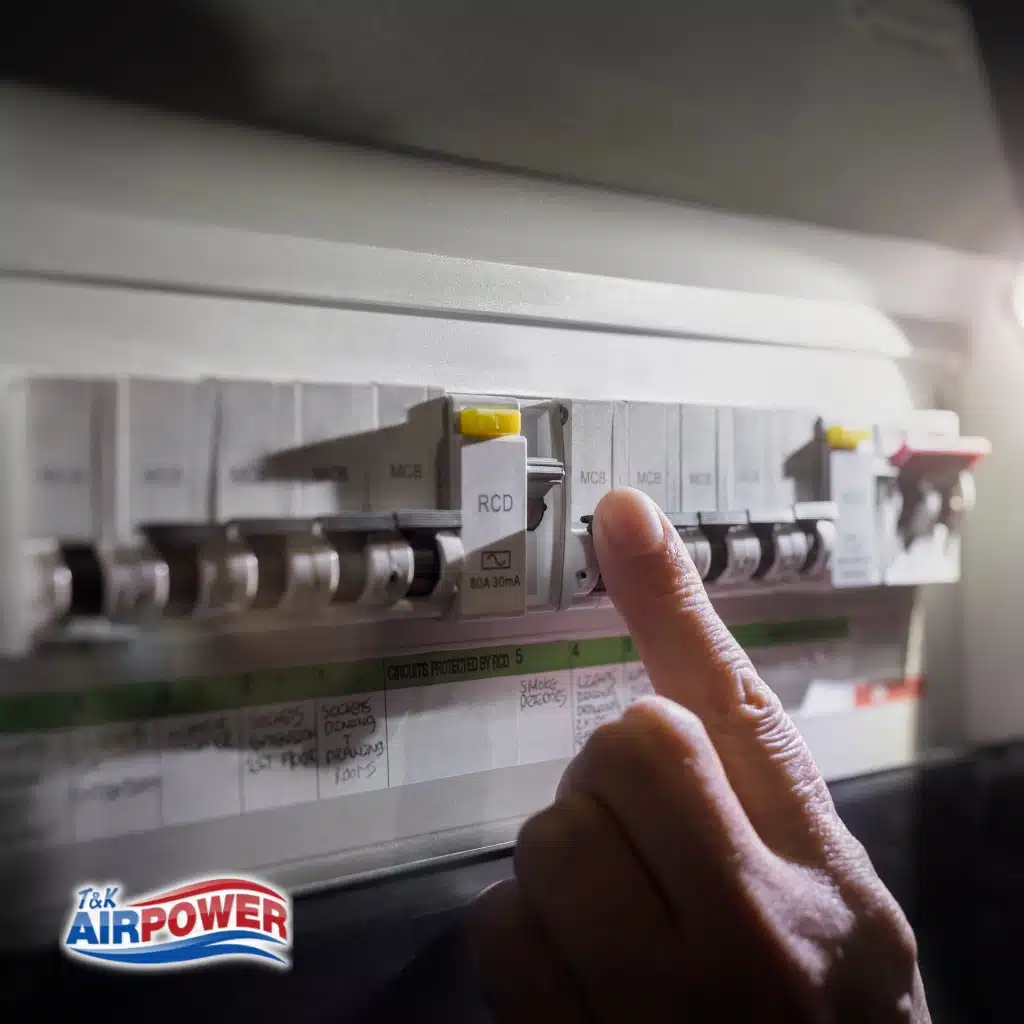 Why Emergency Electrical Repair Is Your Best Defense Against Costly Damage 11 A person resets a circuit breaker switch in an electrical panel to restore power.