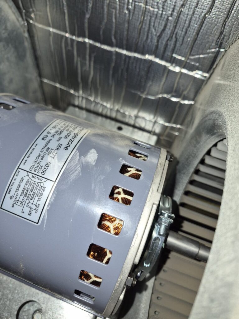 Ducted Air Conditioner Rattling Noise in the Roof: Fan Motors and Blower Wheel Replaced in Mawson Lakes 6 Indoor ducted fan motor with rating label and visible windings inside the air handler
