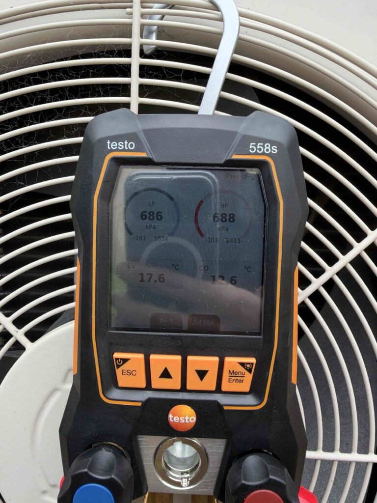 Reverse Cycle Air Conditioner P8 Fault in Kurralta Park: Leaking Schrader Valve and R438A Retrofit Repair 4 Digital manifold gauge on condenser fan guard showing refrigerant pressures and temperatures